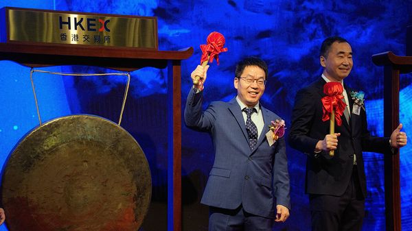 Liu Debing, chairman of Knowledge Atlas Technology JSC Ltd., better known as Zhipu, left, during the company's listing ceremony at the Hong Kong Stock Exchange in Hong Kong, China, on Thursday, Jan. 8, 2026.