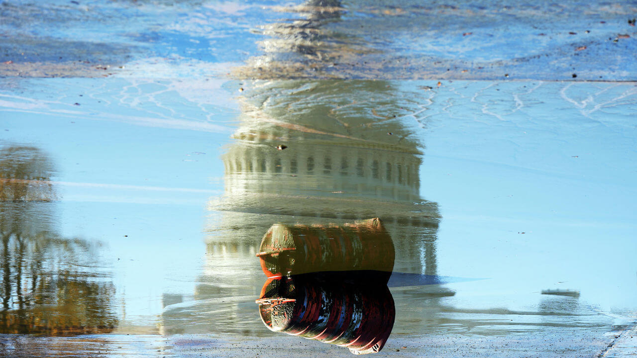 The U.S. Capitol is seen in the drained Capitol Reflecting Pool 