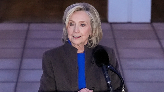 Hillary Clinton speaks into a microphone.