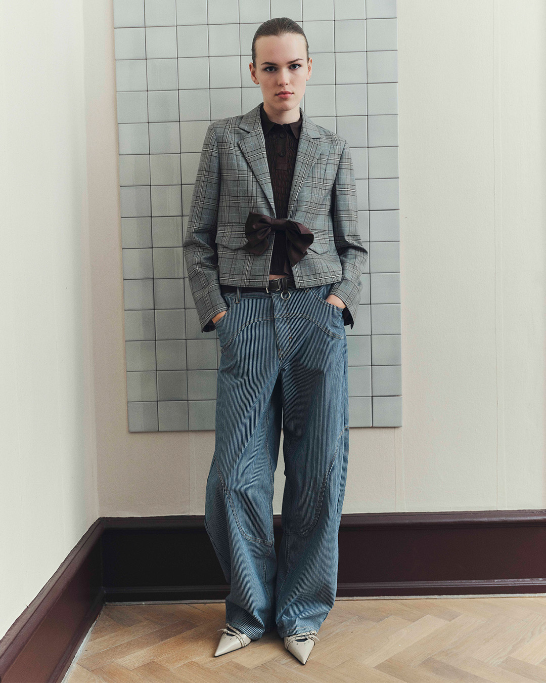 Girl in checked jacket and striped jeans 