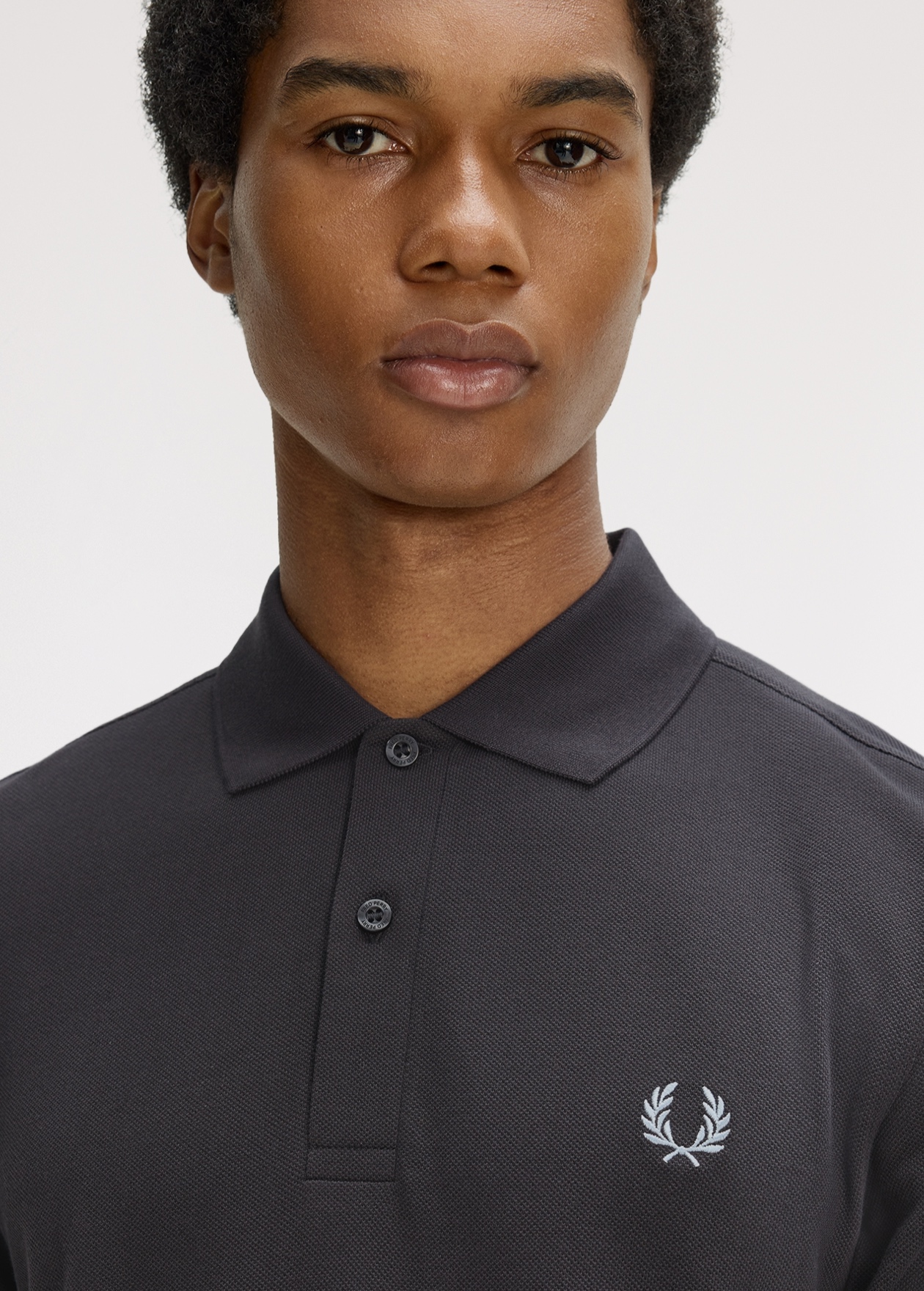 New Releases Men: male model wears Fred Perry Shirt in Anchor Grey