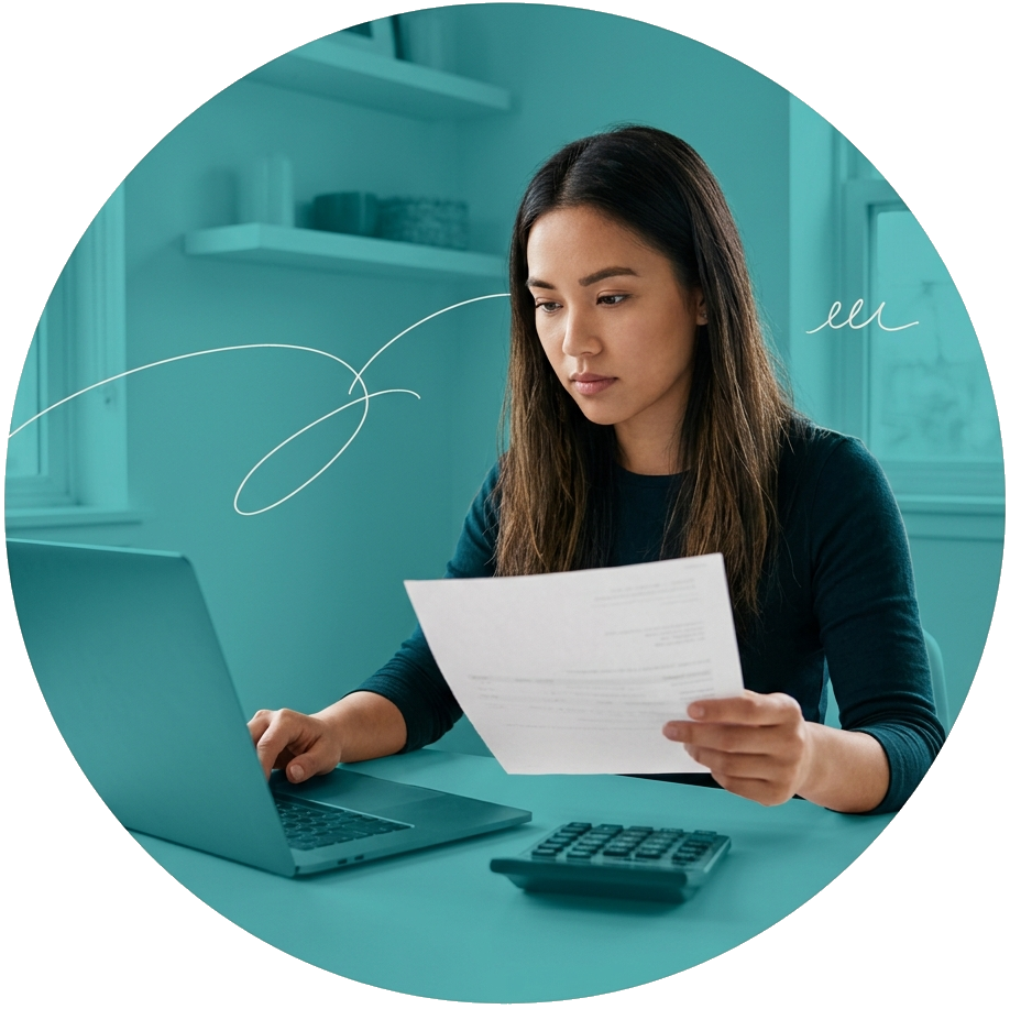 Young woman looking at a paper and her laptop