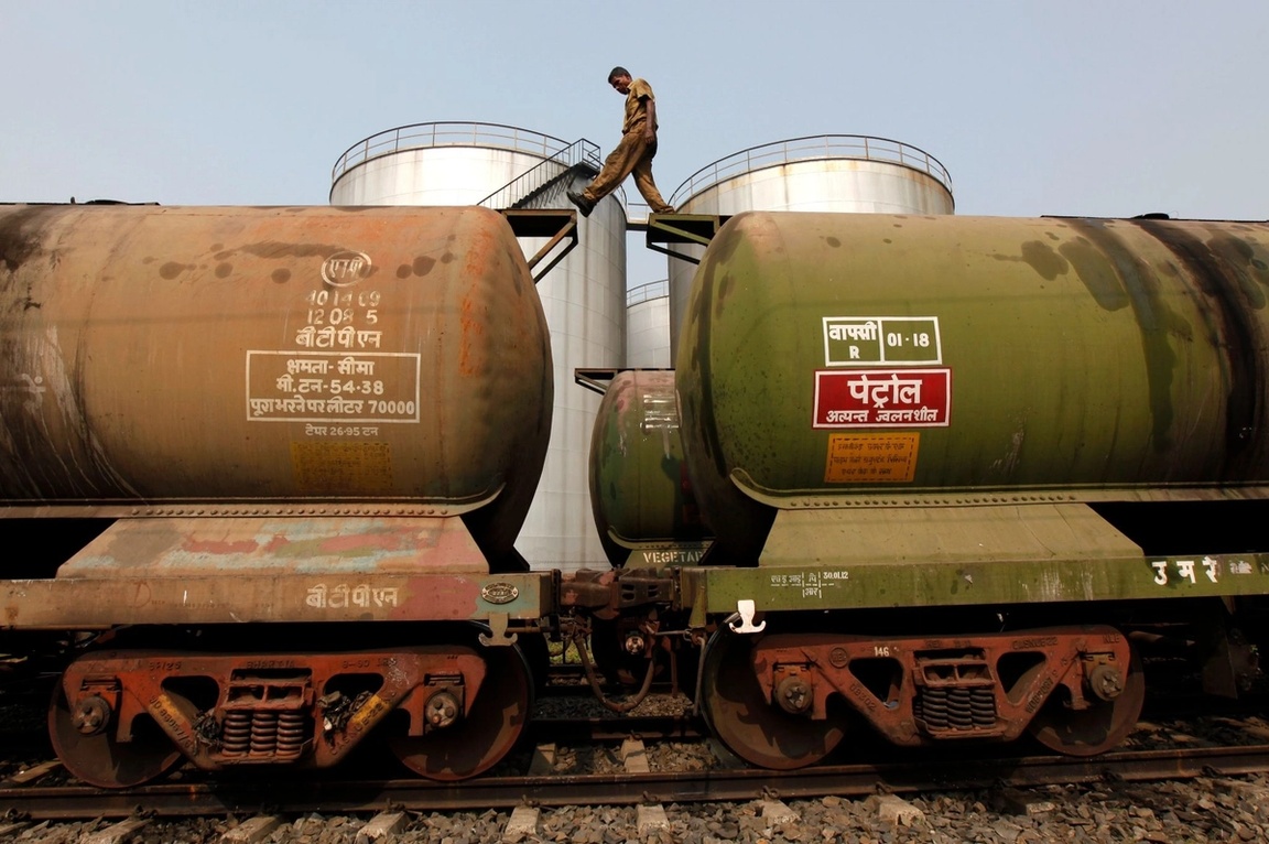 A worker walks atop a tanker wagon in Kolkata. 