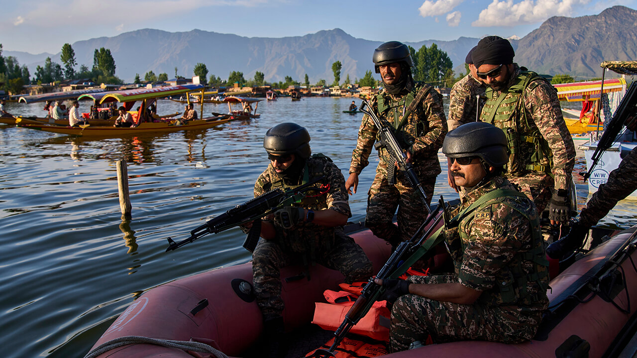 Paramilitary soldiers board a patrol boat as Indian tourists take boat rides on Dal Lake in Srinagar, Indian controlled Kashmir, April 25th 2025