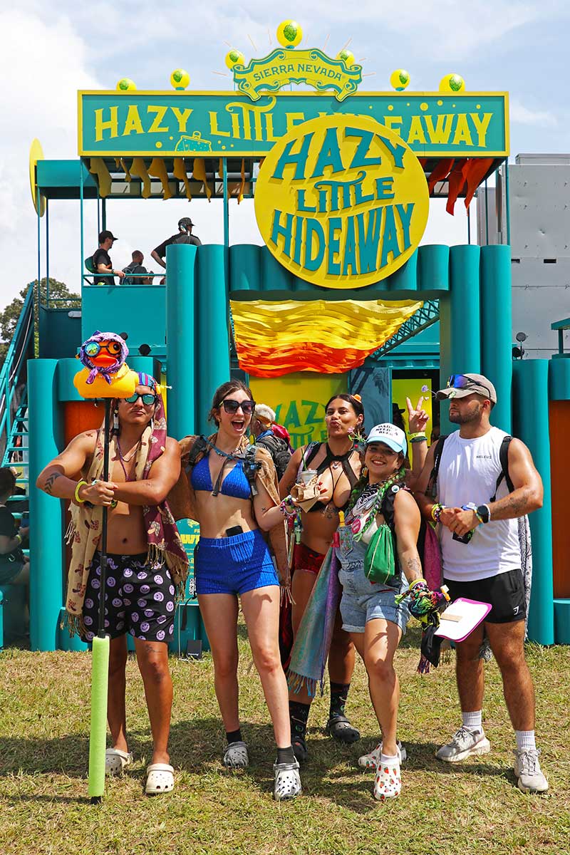 Five friends posing in front of the Hazy Little Hideaway