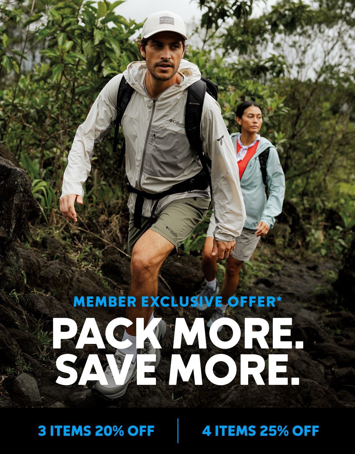 A man and woman are backpacking through a rainforest.