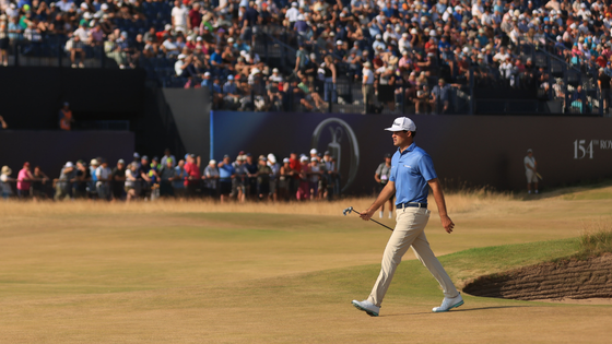 Jackson Suber walks with a golf club.