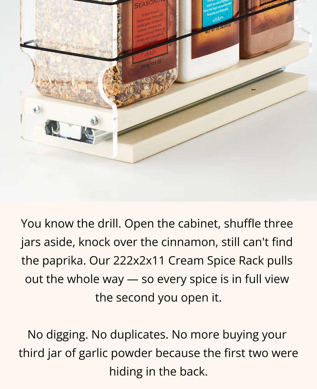 Close-up of spice rack drawer sliding out fully with labeled spice jars visible and easy access design