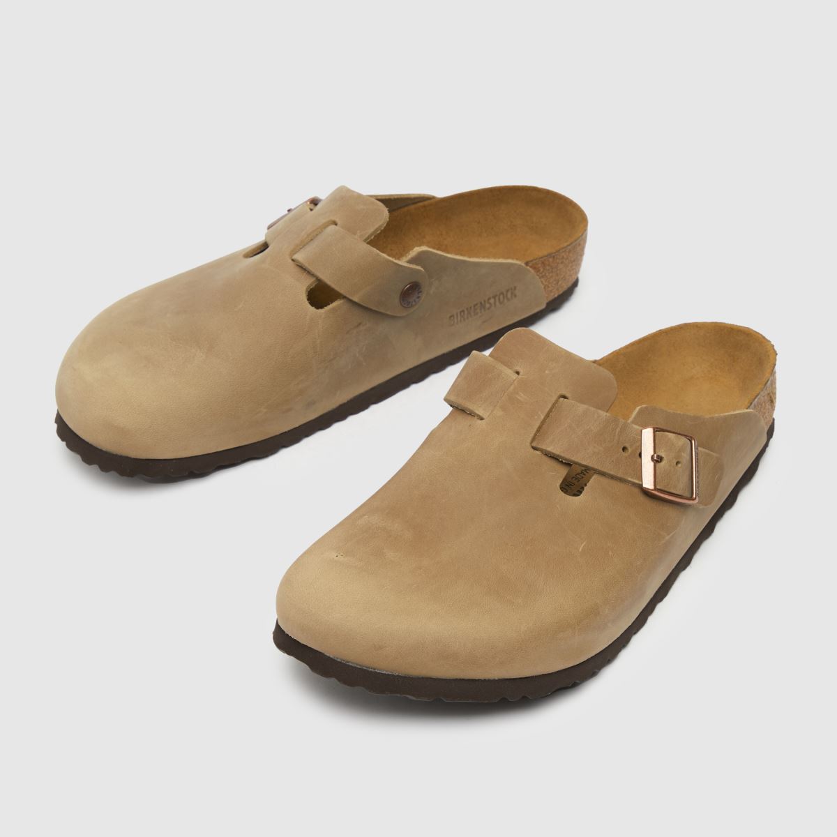 An image of a pair of beige BIRKENSTOCK clogs