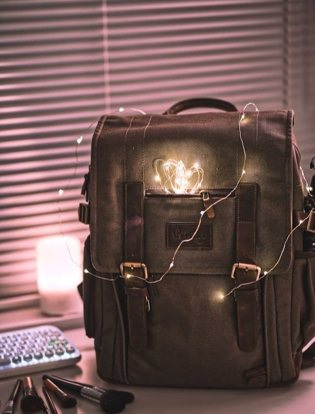 A canvas backpack decorated with string lights.
