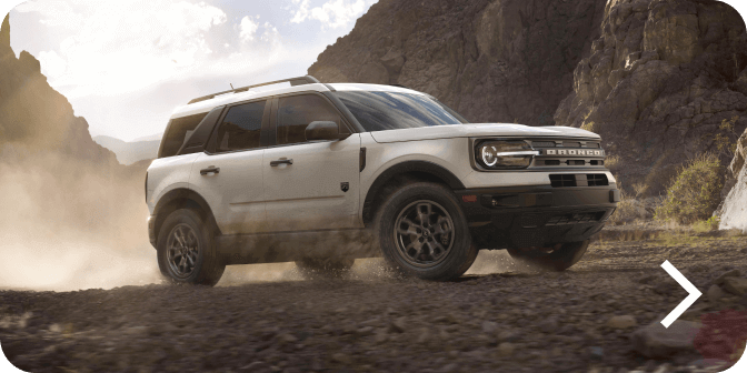 A Bronco&reg; Sport SUV Big Bend&reg; model being driven off‑road in a desert landscape