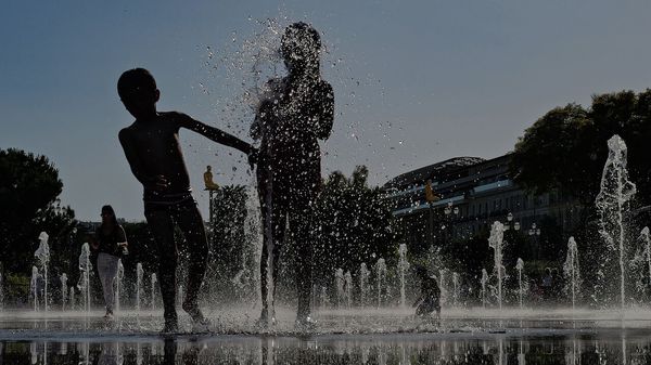Children play in a water fountain in the French city of Nice
