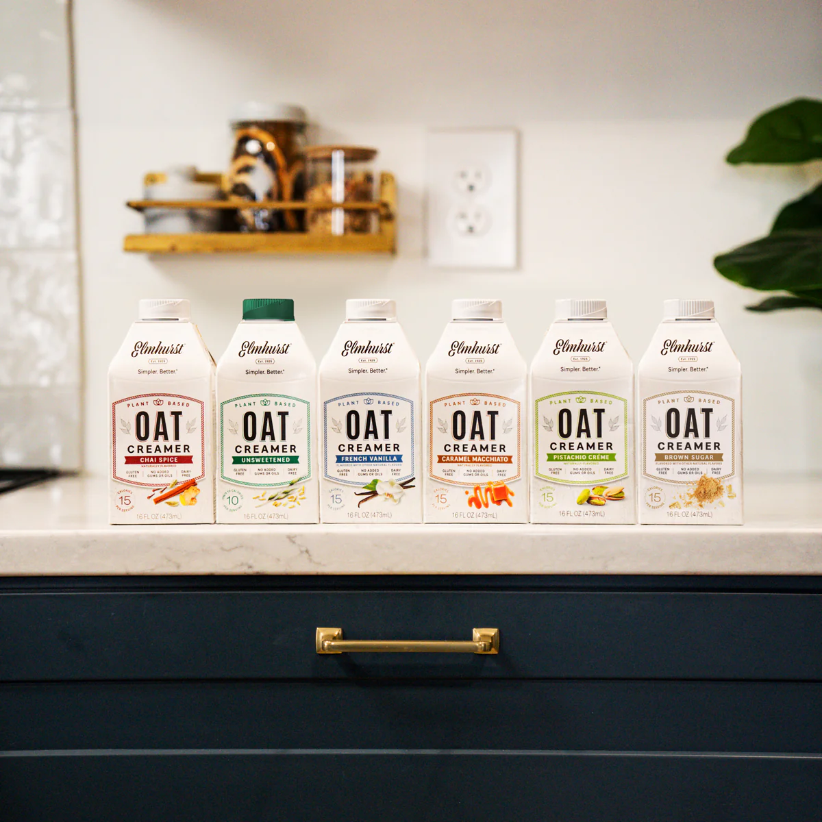 Variety of Oat Creamers lined up on a beautiful kitchen counter