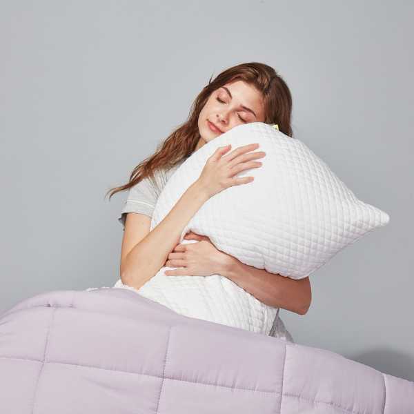 a woman hugging a pillow