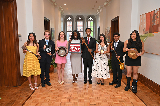 Senior Honor Awards recipients Avia Weber, Bruno Basner, Sydney Finkelstein, Angele Diamacoune, Dahai Yonas, Remy Rabin, Arnav Dhingra, and Vedika Jawa holding objects for Ivy Day.
