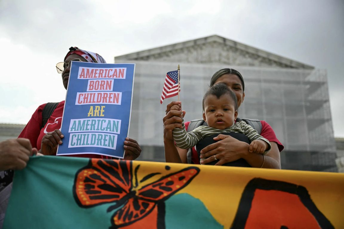 Women and baby rally outside Supreme Court