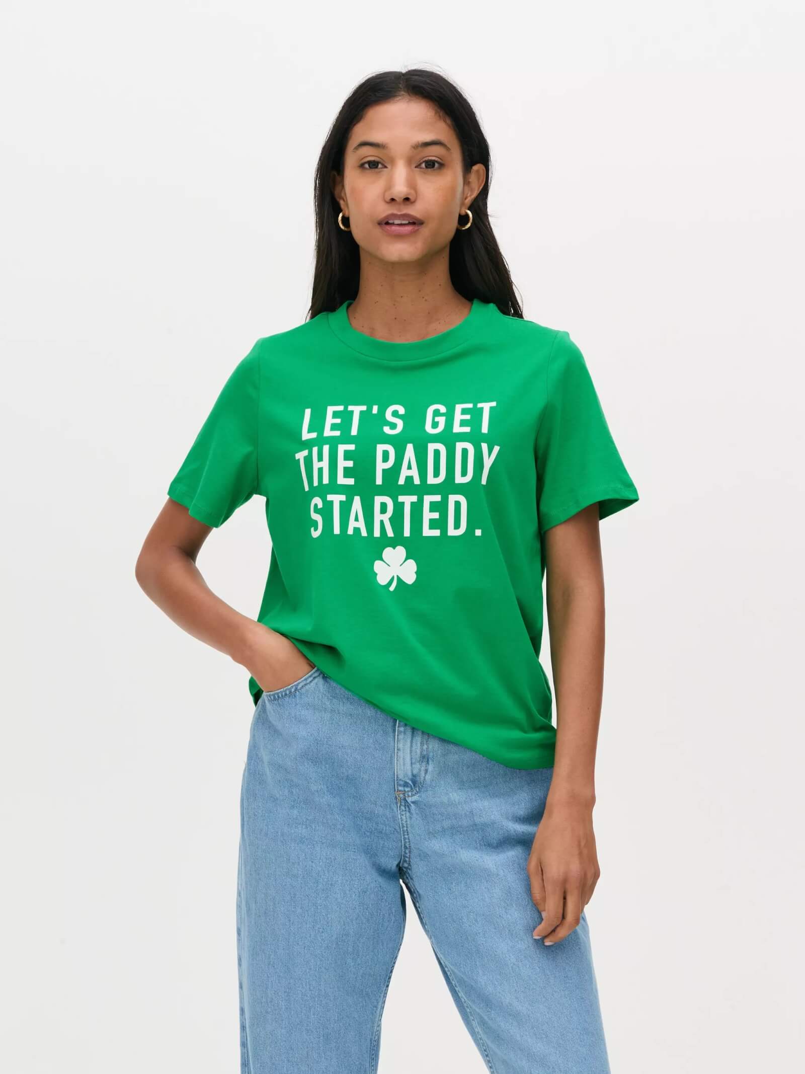 Woman wearing a St-Patrick's Day green t-shirt and blue jeans
