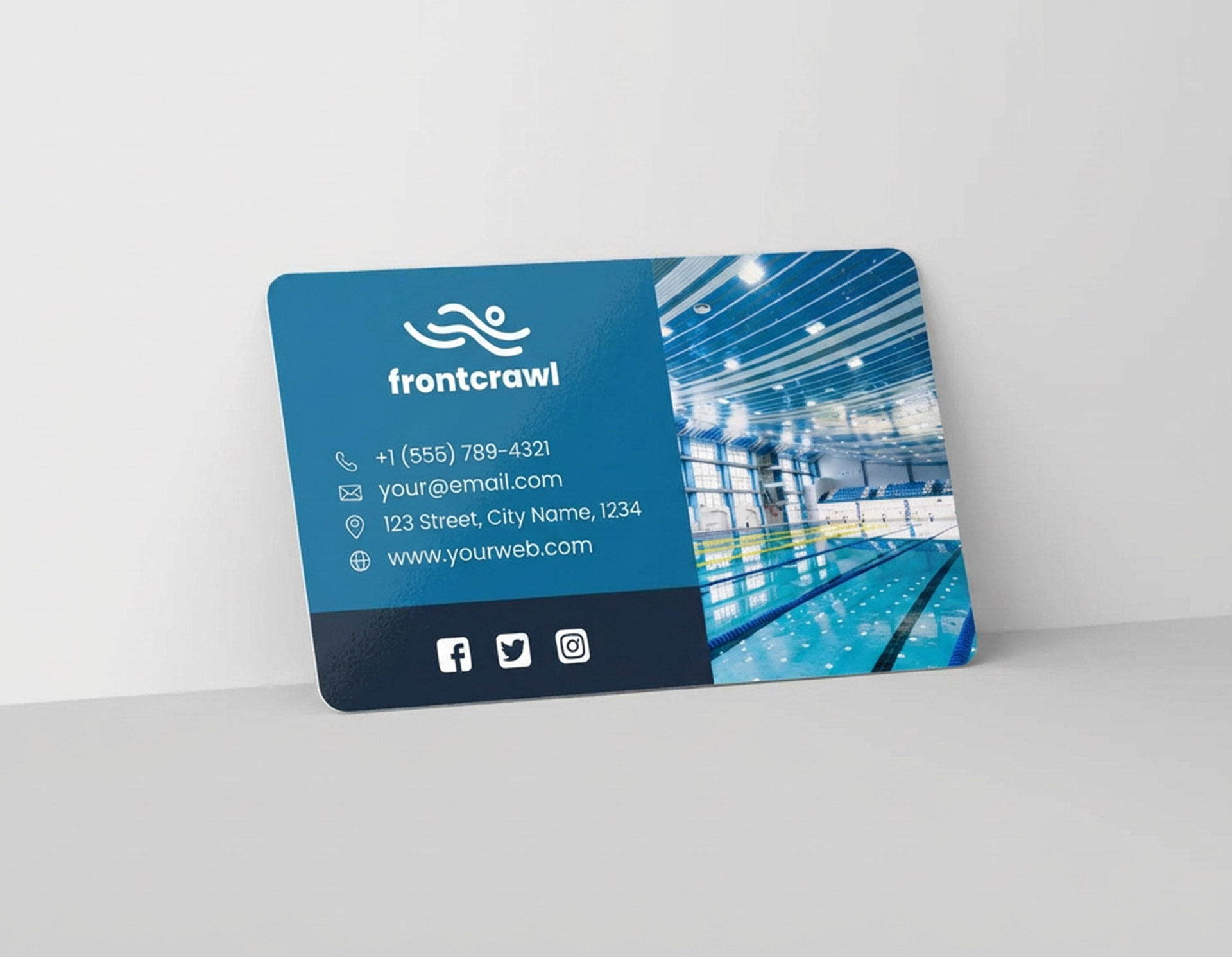 Blue plastic business card for “frontcrawl” swim center with contact details and indoor pool image.