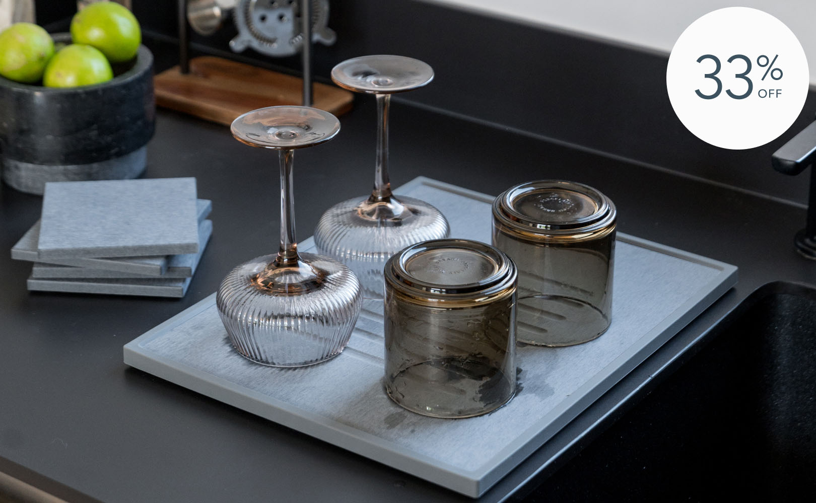 Inverted glasses and coasters on kitchen counter.