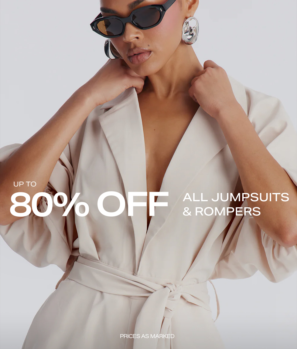 Elegant model in a cream belted jumpsuit, black cat-eye sunglasses, and silver earrings. Shop the 80% off sale on all jumpsuits & rompers!