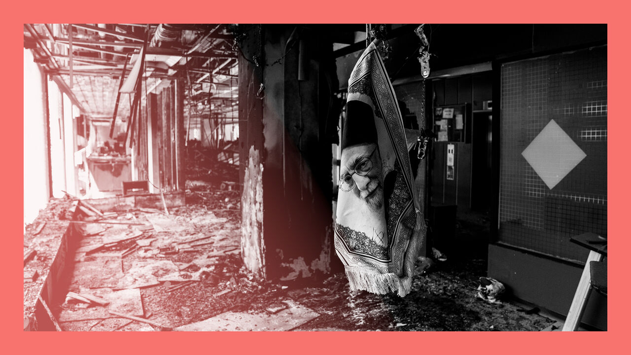 A portrait of Ayatollah Ali Khamenei dangles in a damaged building used by the Iranian Broadcasting Organisation, hit by Israeli missiles.