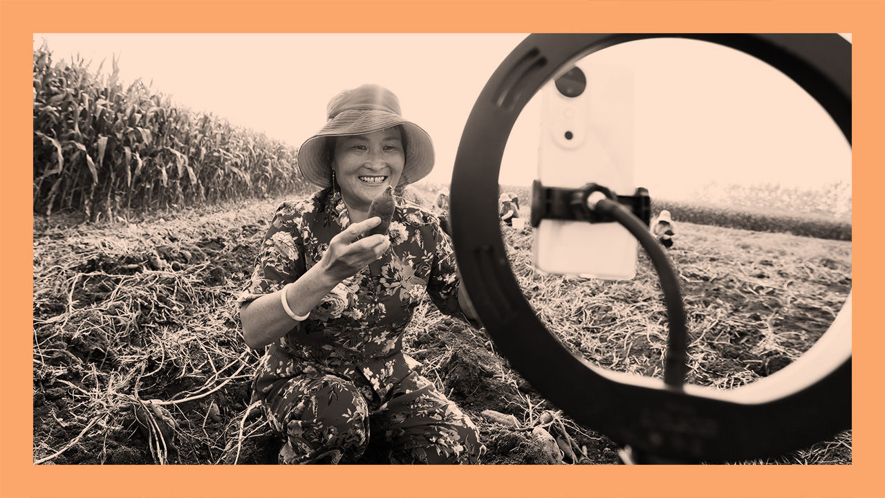 A farmer promotes sweet potatoes through a live webcast in a field in Suqian, Jiangsu province, China
