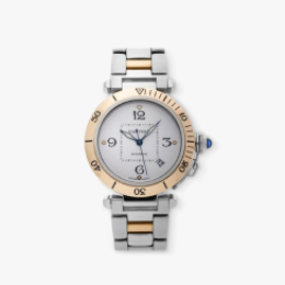 A Cartier Pasha watch in stainless steel and 18-carat pink gold on a gray tile.