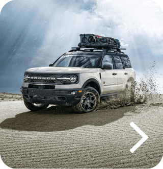 A Bronco&reg; Sport SUV Badlands&reg; model being driven off road and kicking up dirt