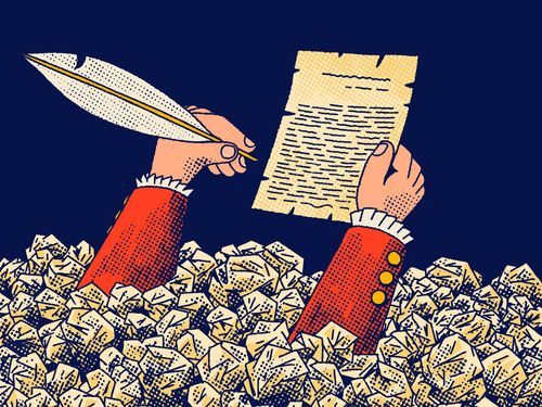 A person writing in a stack of paper