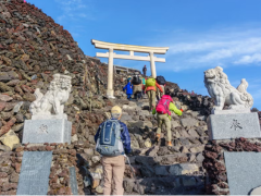 Photo of 102 year old hiker on the top of a mountain.