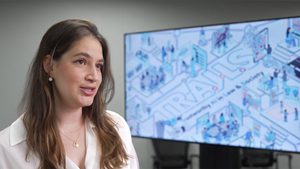 Researcher speaks in front of screen with TRAILS logo