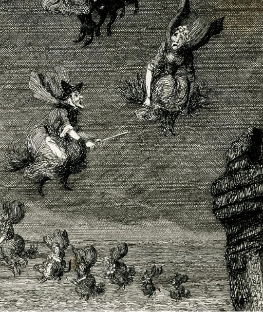 A coven of witches flying on broomsticks.