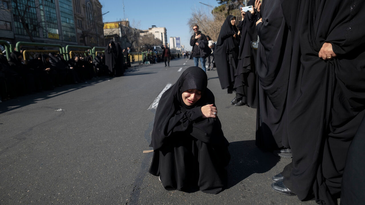A veiled Iranian woman mourns during a rally in Tehran.