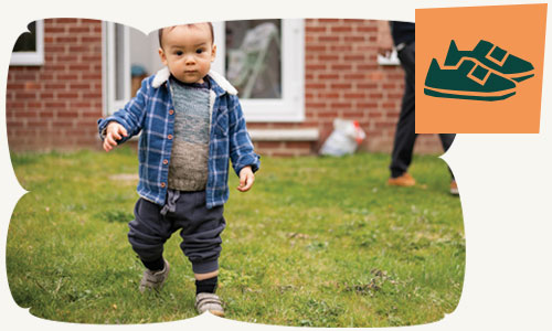 A toddler toddling in the garden
