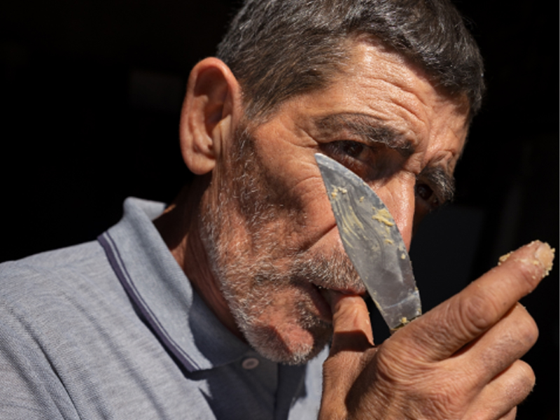 A man samples a piece of cheese