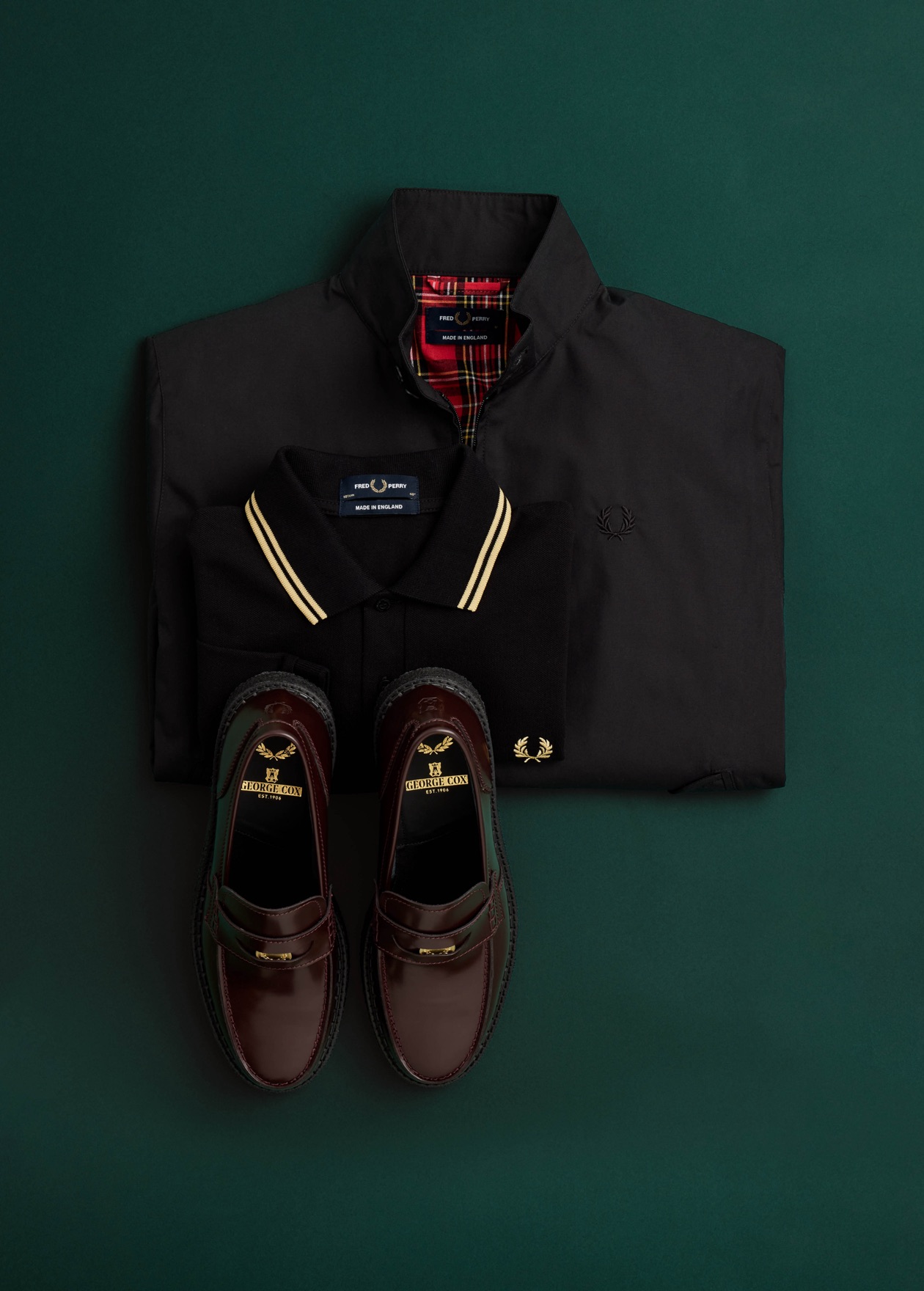 Male model with wolf cut wears a long sleeved Fred Perry shirt 