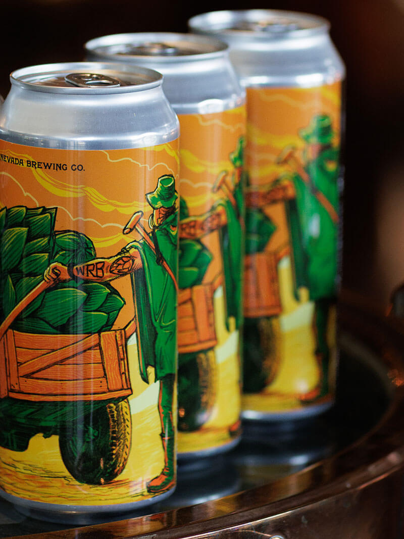 Three cans of Who Run Bartertown? on a table