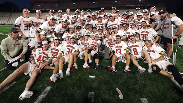 Maryland men's lacrosse team poses for photo with trophy