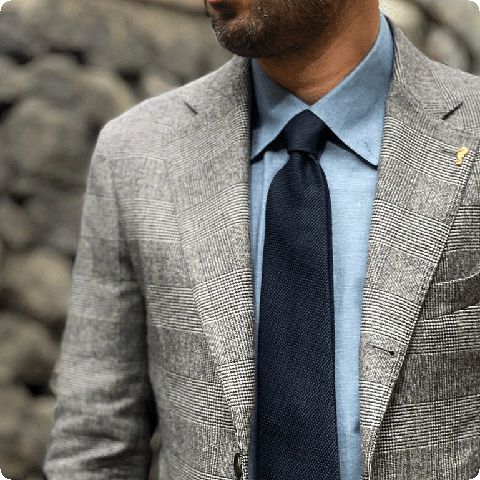 Close up of a stylish silk grenadine tie in navy