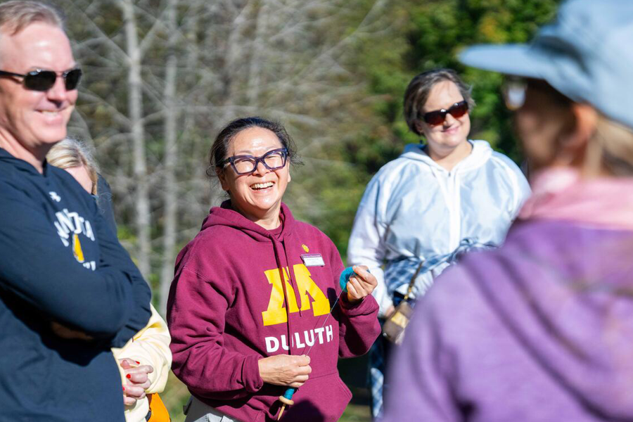 Krista Twu smiles with community members.