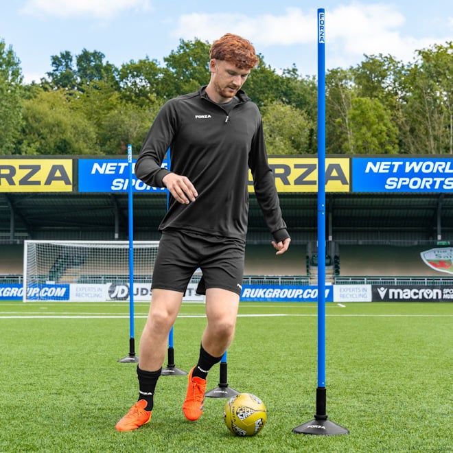 Player controllingthe ball between FORZA Slalom Training Poles.