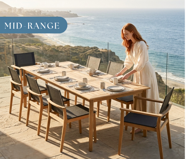Image of woman setting a POVL Outdoor Menlo dining set on an oceanfront patio