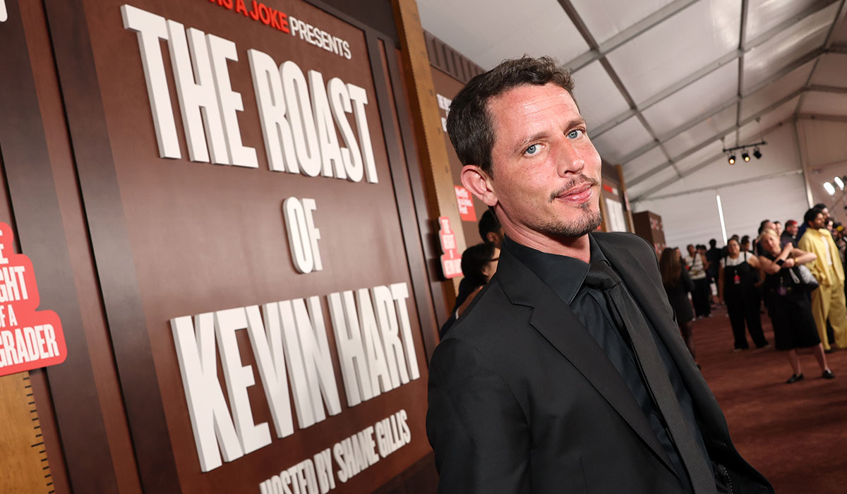 Man poses on red carpet.