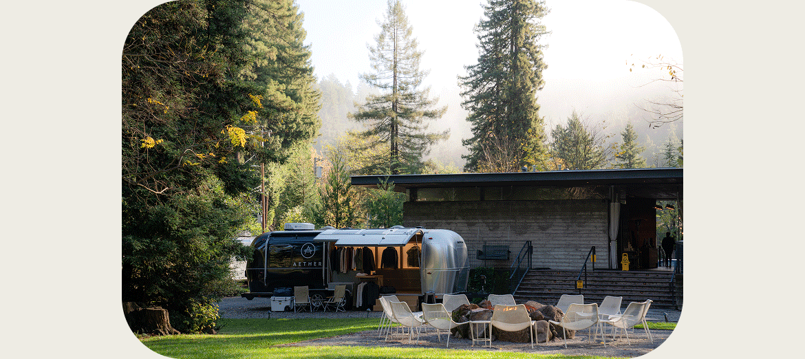 Image slideshow of the new AETHER airstream interior with lighting fixtures and clothing display.