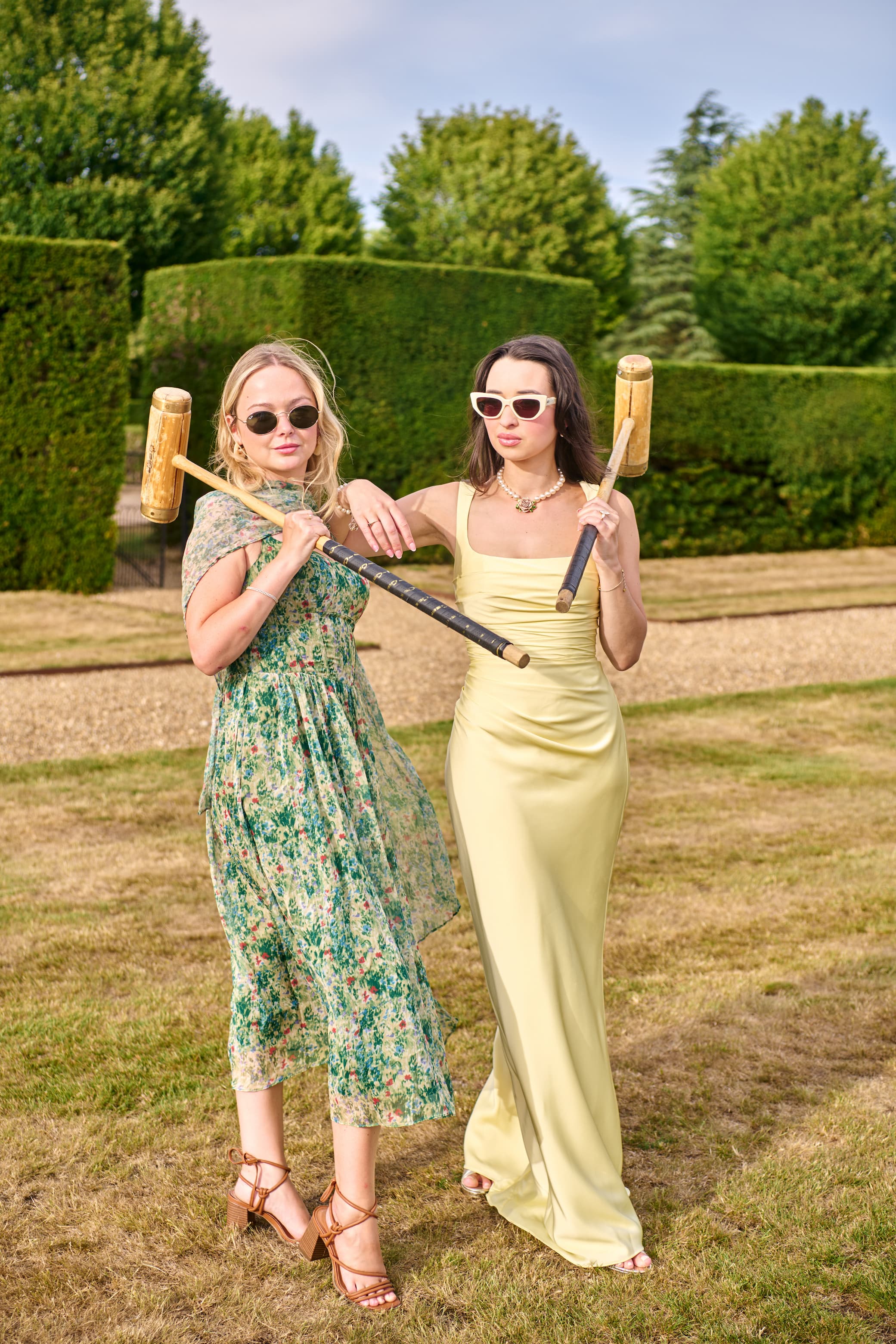 Guests celebrating a summer occasion at the beautiful Hedsor House estate in Azazie dresses