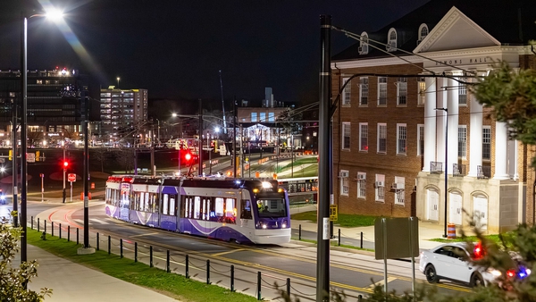 Purple Line vehicle on tracks on campus at night