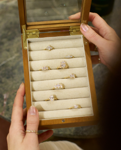 Chupi holds a show box with a variety of iconic rings 