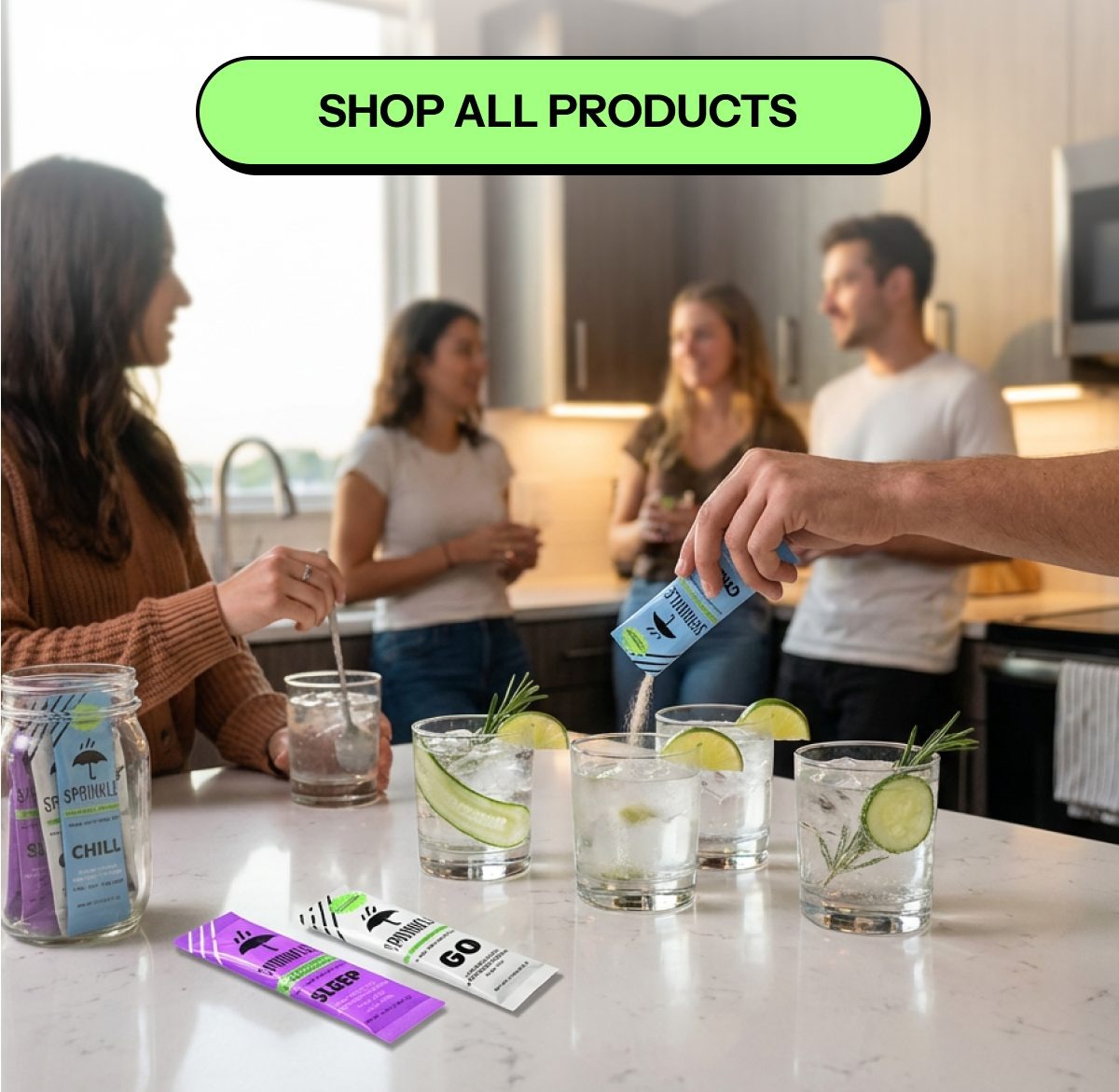 People enjoying drinks at a kitchen counter with garnishes and mixers.