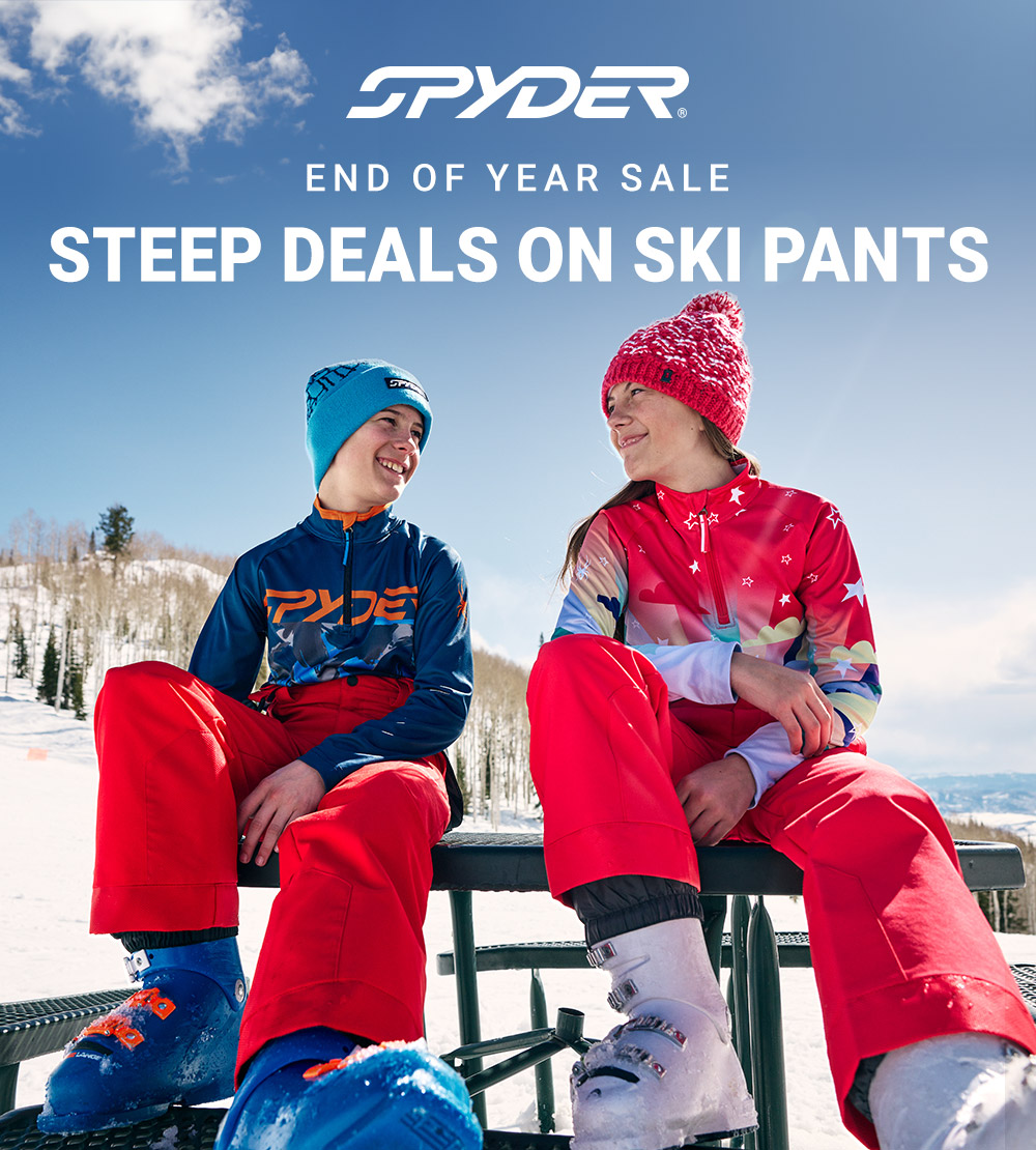 Two skiers sitting on a bench highlighting ski pants. Spyder logo. Message: End of Year Sale. Steep Deals on Ski Pants.