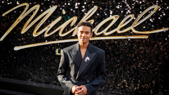 Jaafar Jackson poses in front of a Michael sign